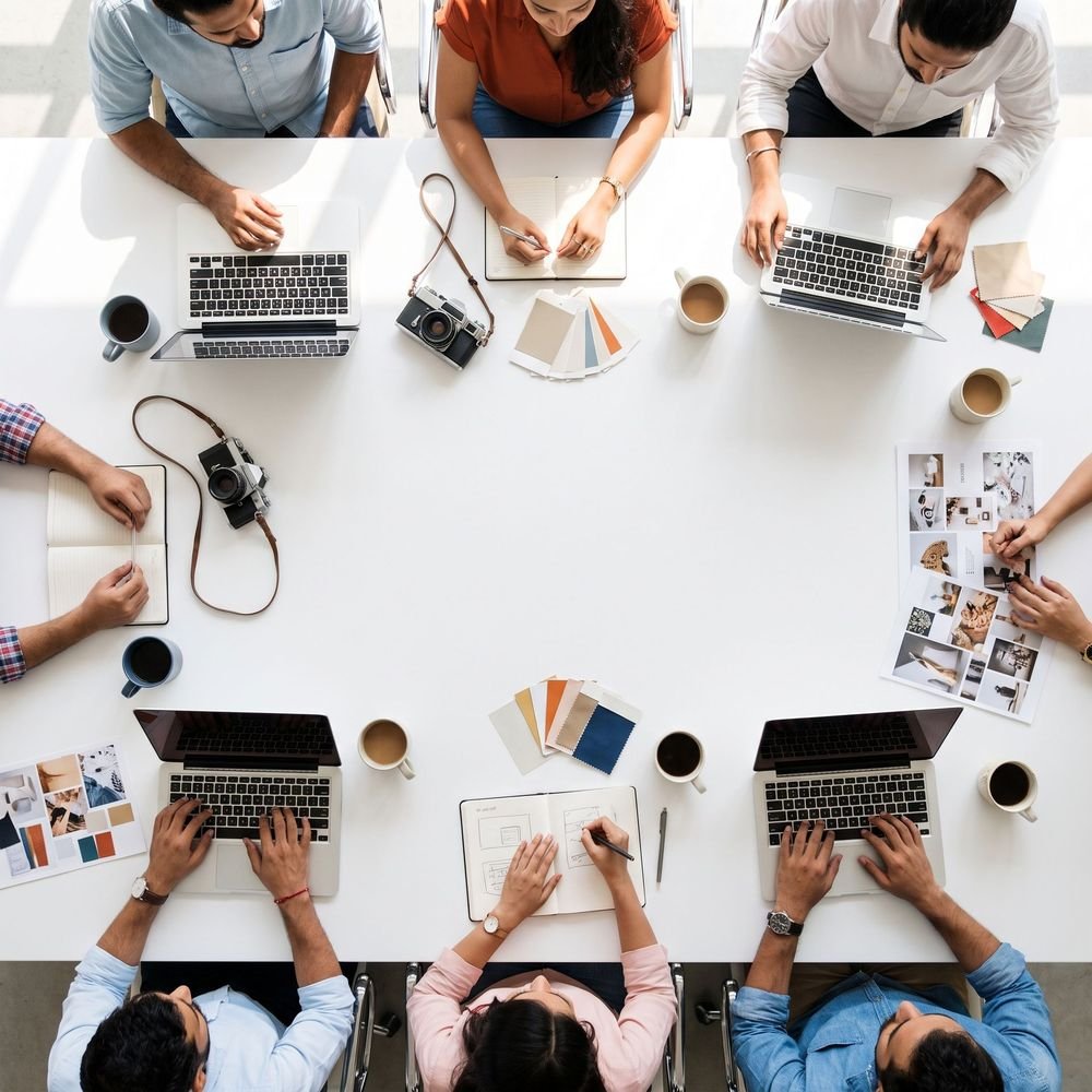 Creative team gathered around a table – Colour Cube Media